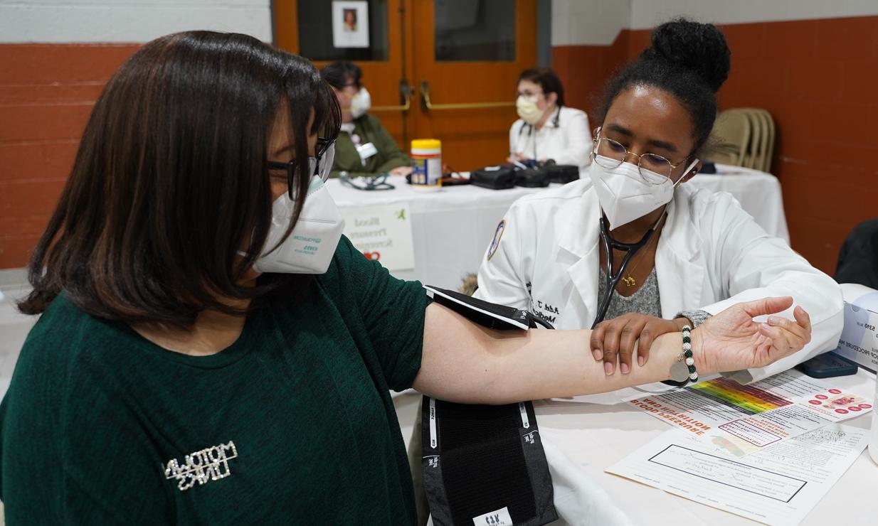 An image of a student taking blood pressure.